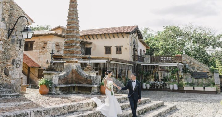 Newlywed couple walking through a historic stone venue during their destination wedding in the Dominican Republic.
