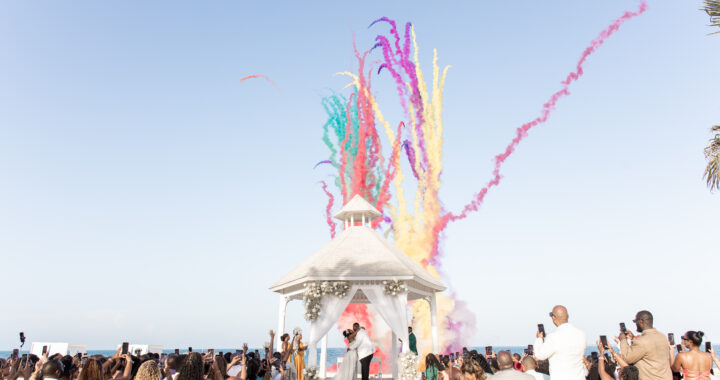 Colorful confetti moment during a beachfront wedding ceremony at a Punta Cana resort.
